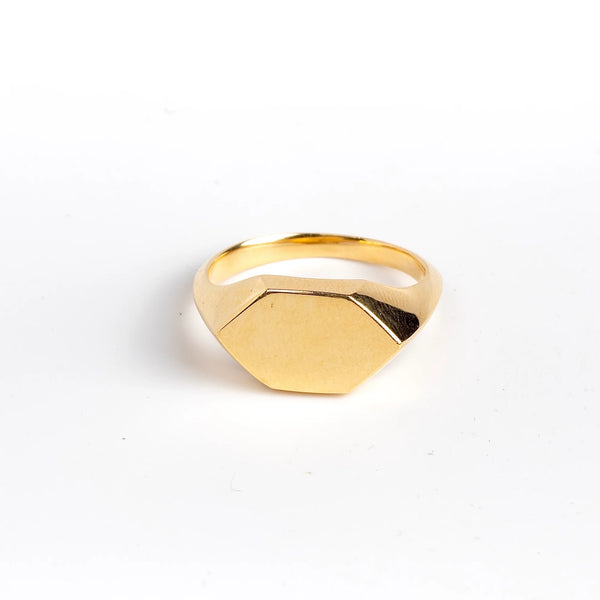 Hexagonal Reflection Signet ring by Makiko Wakita is an 18k high polish signet ring with crisp edges and a hexagonal face. The band has s beautiful knife edge. This signet ring is unisex. A Handmade in Los Angeles. 