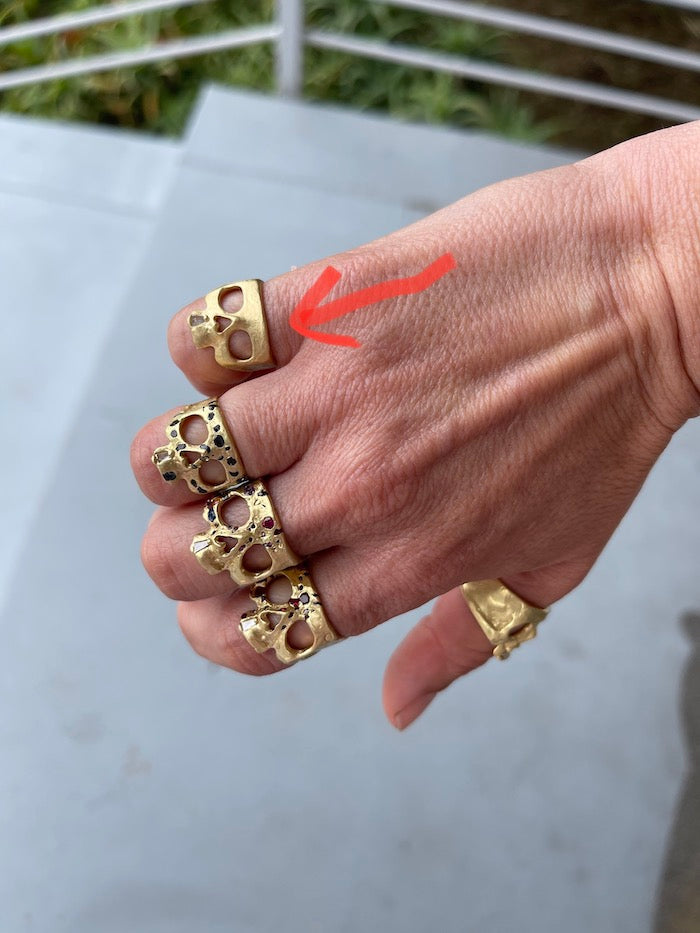 
            
                Load image into Gallery viewer, Wearing the Mini Snaggle Tooth Skull ring by Polly Wales with baguette diamond snaggle tooth.
            
        