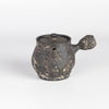 Kyusu teapot B by Muzuri Ware is a composed ceramic teapot, utilizing mostly black stained London clay, textured and inlayed with costal wild Cornish clay. This one is inlayed with black iron oxide. Wheel thrown and assembled with interior holes to work with a variety of tea leaves by Kyriacos Mouzouris in London UK.