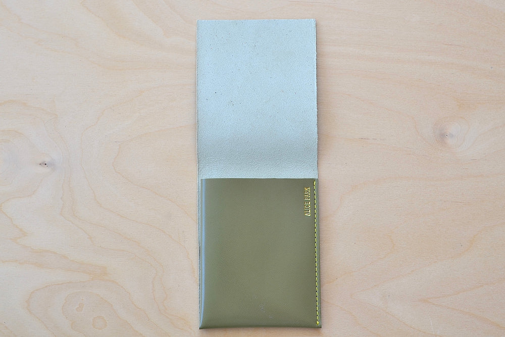 
            
                Load image into Gallery viewer, Inside of Olive Alice Park simple flap wallet with yellow stitching.
            
        