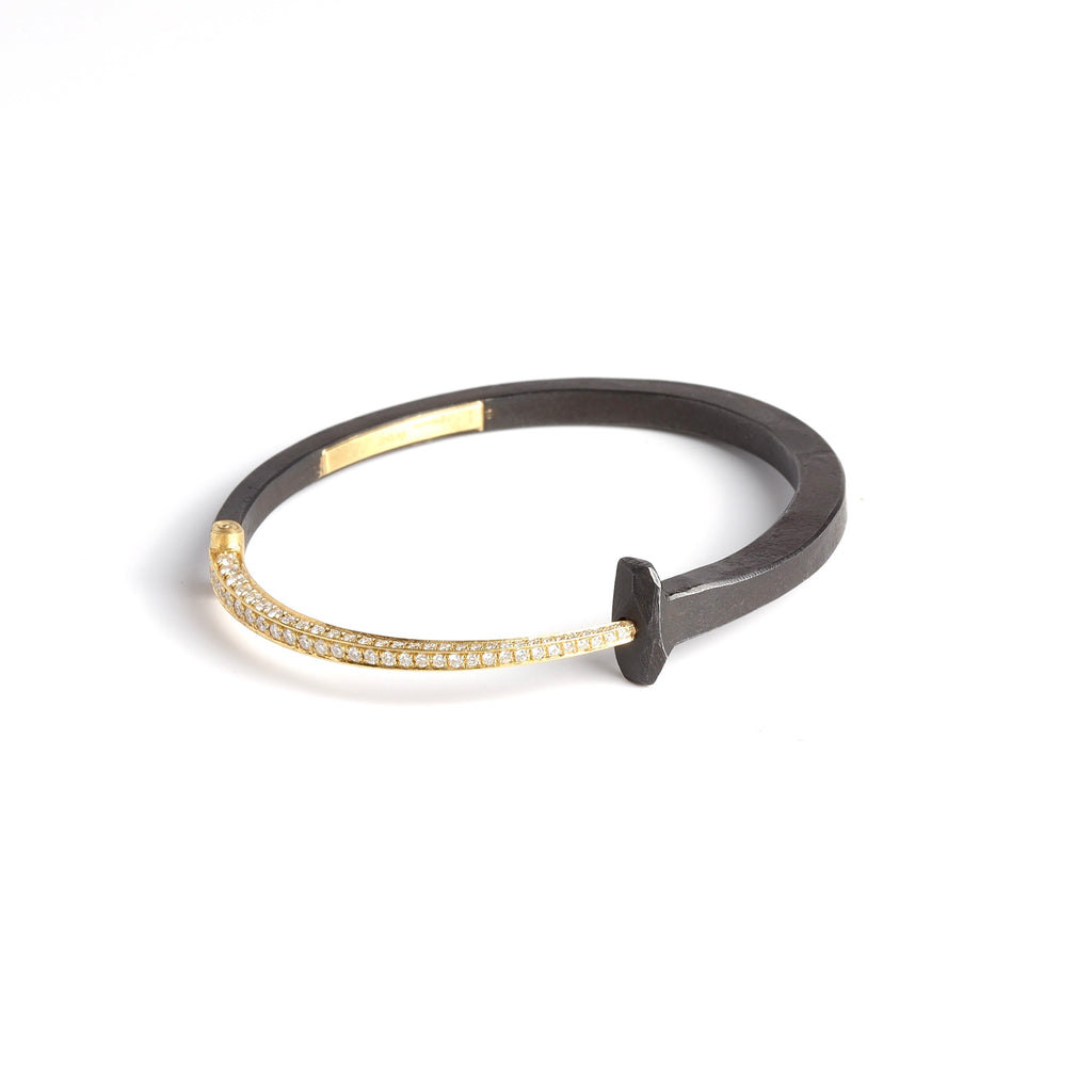 The Pat Flynn Nail Bracelet with pave tail on white background.