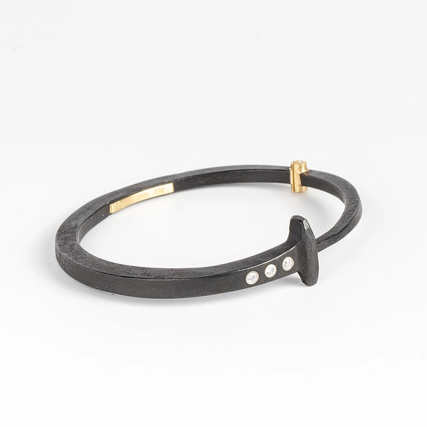 Pat Flynn Three stone Nail Bracelet Forged Blackened iron Diamonds, 18k gold hinge on white background.