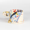 Alternate side of EXP Standard Splatter Mug in Yellow, Peach, Pink, Blue and Black