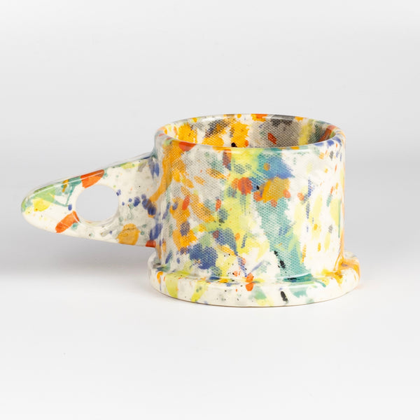 EXP Standard Splatter Mug in Yellow, Orange, Green, Blue and Gray is a glazed ceramic mug with a triangular handle, made by utilizing slab construction that is hand rolled. Inspired by the techniques of Adrian Saxe and the paintings of Sam Francis, the mug was designed by LA artist, Peter Shire for Echo Park Pottery. Peter is one of the original members of the Memphis Group, founded by Ettore Sottsas in Italy. Handbuilt in Echo Park, Los Angeles.