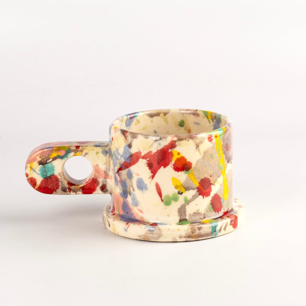 Alternate side of EXP Standard Splatter Mug in Pink with Yellow and Turquoise Stripes by cho Park Pottery and Peter Shire.