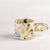 EXP Standard Splatter Mug in Blue, Orange and Purple Spots is a glazed ceramic mug with a rounded handle, made by utilizing slab construction that is hand rolled. Inspired by the techniques of Adrian Saxe and the paintings of Sam Francis, the mug was designed by LA artist, Peter Shire for Echo Park Pottery. Peter is one of the original members of the Memphis Group, founded by Ettore Sottsas in Italy. Handbuilt in Echo Park, Los Angeles.