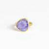 The Tanzanite Greek Ring by Pippa Small Jewellery is an organically shaped, and hand cut, bright purple, faceted and translucent tanzanite stone set in 18k yellow gold. Size 6 in stock.