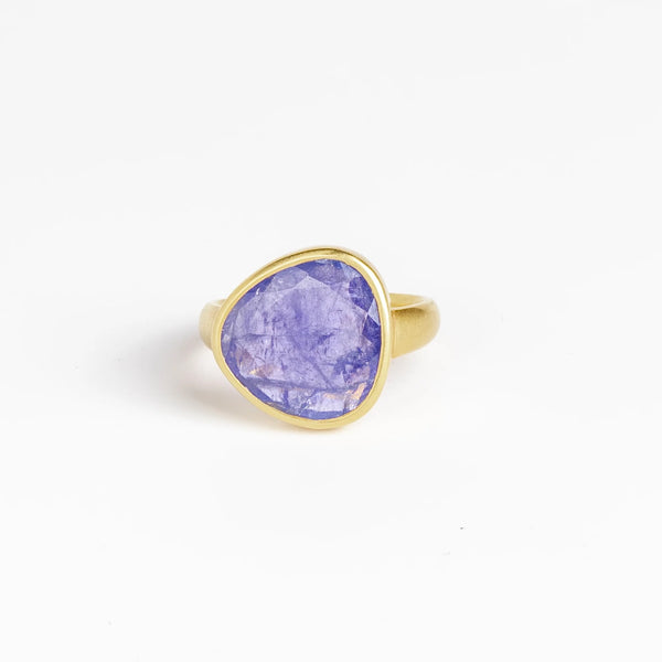 The Tanzanite Greek Ring by Pippa Small Jewellery is an organically shaped, and hand cut, bright purple, faceted and translucent tanzanite stone set in 18k yellow gold. Size 6 in stock.