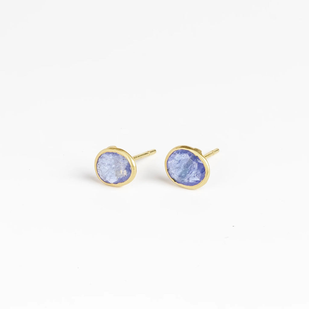 Angled view of the new and smaller version of Pippa Small Classic Stud studs earrings in Tanzanite and 18k yellow gold