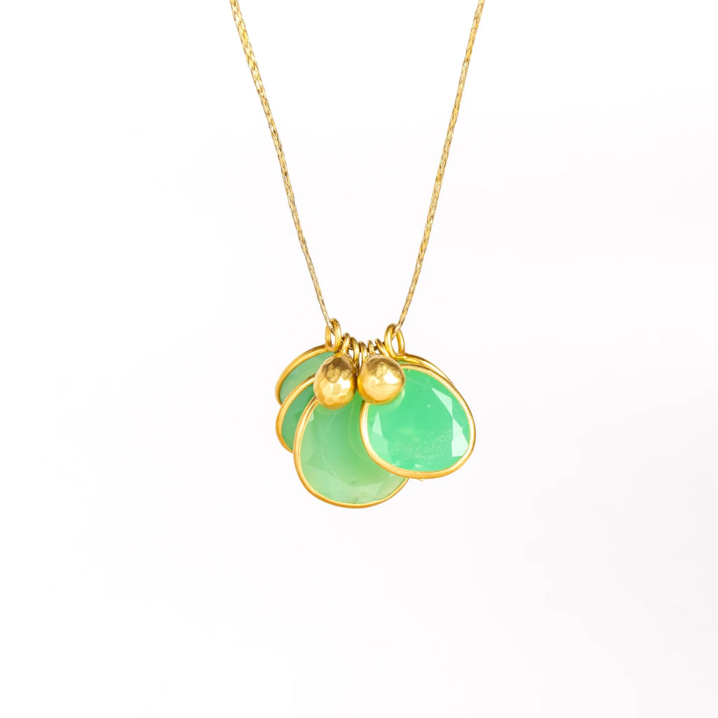 Colette Cluster Necklace in Chrysoprase on white background with Gold Drops designed by Pippa Small is a Cluster of chrysoprase pendants bezel set stones in various sizes with two (2) 18k gold beads on 22" golden waxed cotton cord also known as the Flourishing Green necklace.