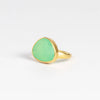 The Chrysoprase Greek Ring by Pippa Small Jewellery on white background  is an organically shaped, and hand cut, bright green, faceted and translucent chrysoprase set in 18k yellow gold. Size 6.5 in stock.