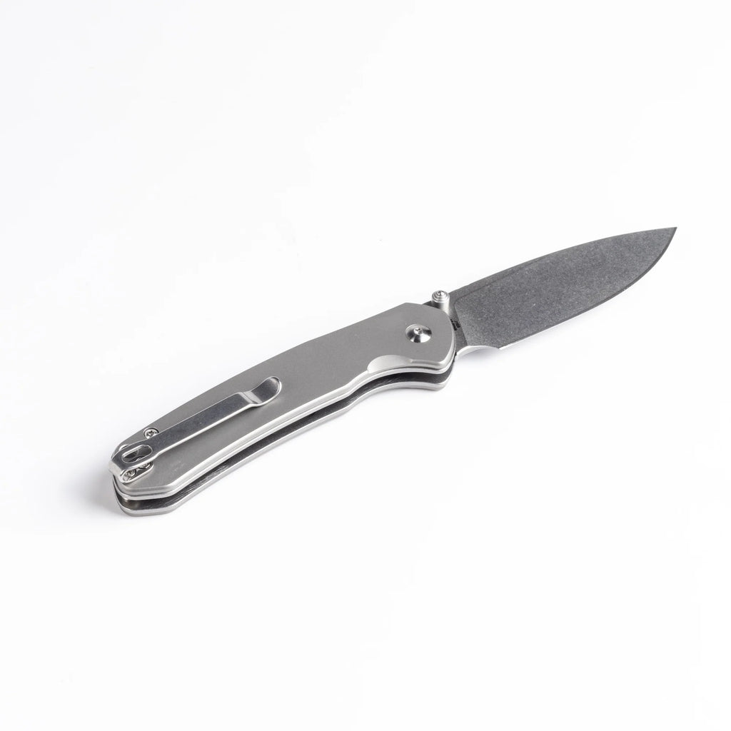 Pyrite Button Lock Titanium Knife on white background.