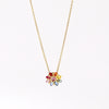 Daisy necklace in Rainbow by Polly Wales with pink cabochon center and rainbow  inverted and encrusted brilliant sapphires in hot pink, pink, lilac, blue, orange, green, and yellow. 