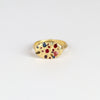 Polly Wales Elysian Ring in Rainbow sapphires (red, pink, blue, purple, green) with knife edge band in 18k recycled yellow gold that is cast not set confetti signet or pinky ring on white background.