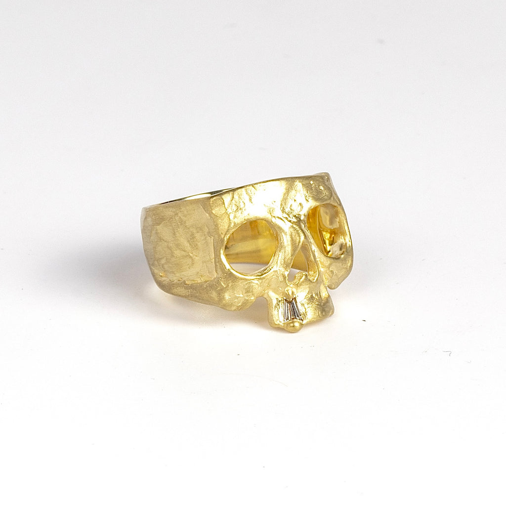 Side view of perfect 18k yellow gold snaggle tooth skull ring by Polly Wales.