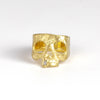 Snaggle Tooth Skull ring by Polly Wales on white is an 18k gold squared skull ring with a white diamond baguette snaggle tooth. Available in size 7 and 7.5 at OK store, Los Angeles.