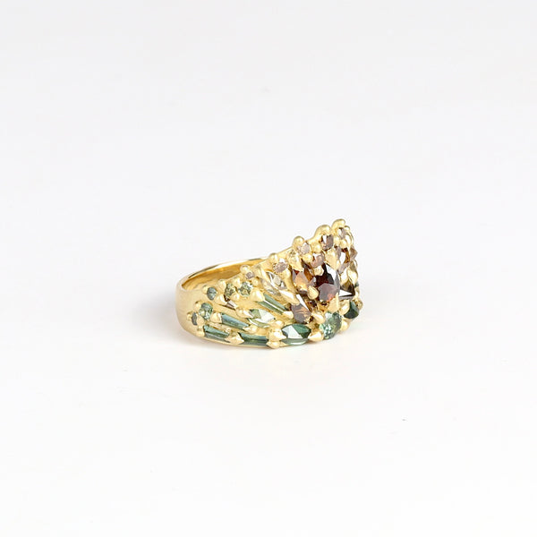Side view of Mossy Bog Uber Encrusted Neli Half Shield in green sapphires and diamonds by Polly Wales.