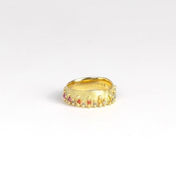 Noelle ring by Polly Wales showing marquise cut sapphires in pink, orange, yellow and green in between brilliant cut grey gray diamonds.