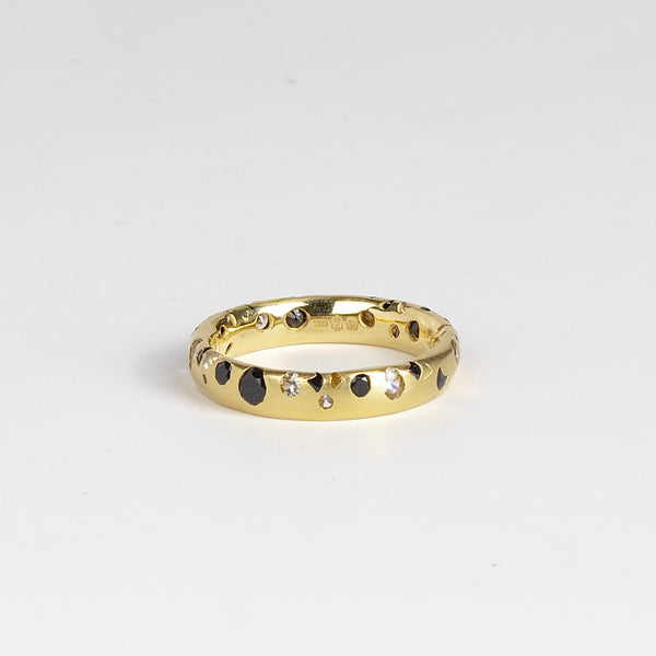 Black and White Confetti Band by Polly Wales is a narrow 18k yellow gold band with speckled black and white sapphires around the circumference for a beautiful confetti-like appearance. Recycled gold. Cast not set. Handcrafted in Los Angeles. Sie 6.5 n stock