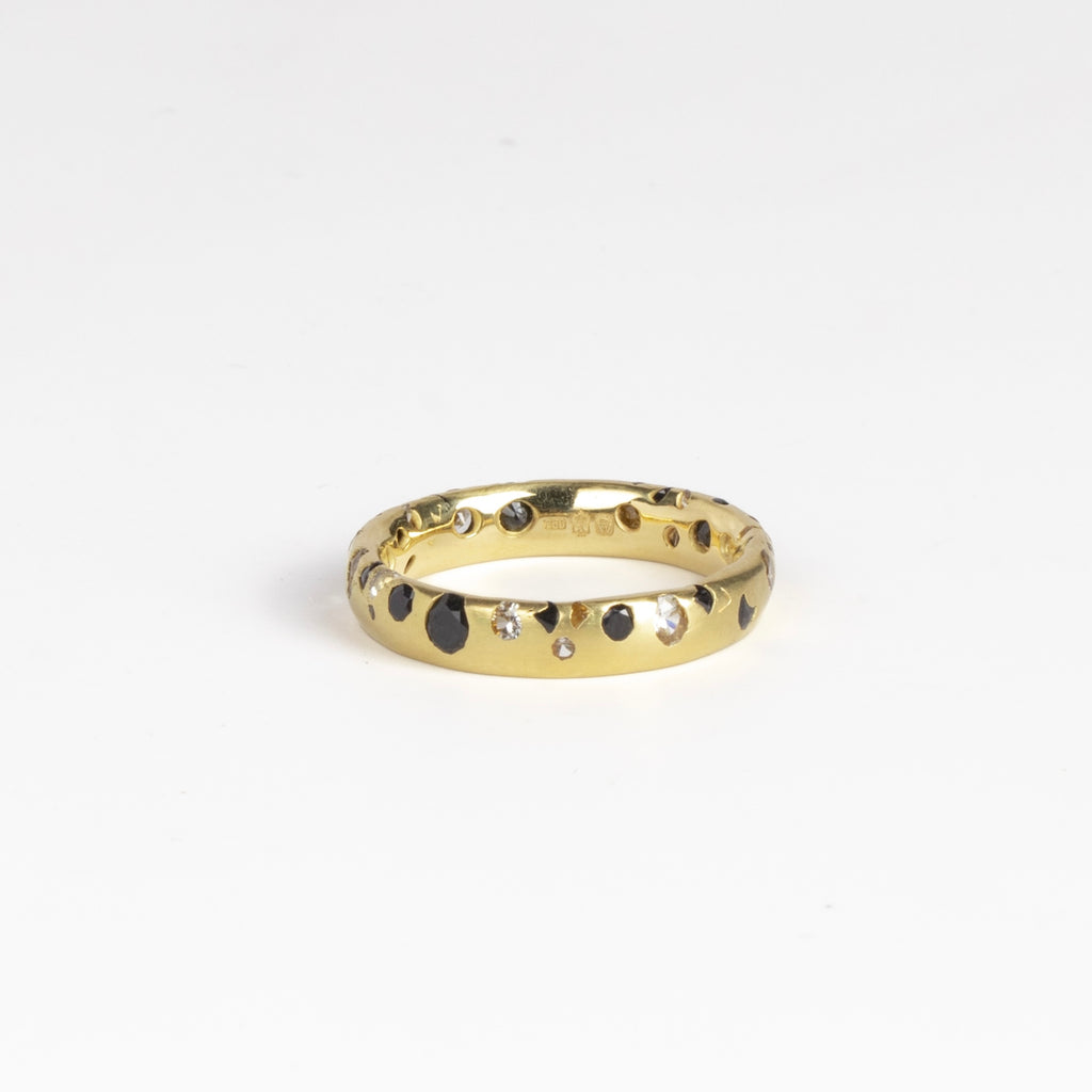 Black and White Confetti Band by Polly Wales is a narrow 18k yellow gold band with speckled black and white sapphires around the circumference for a beautiful confetti-like appearance. Recycled gold. Cast not set. Handcrafted in Los Angeles. Sie 6.5 n stock