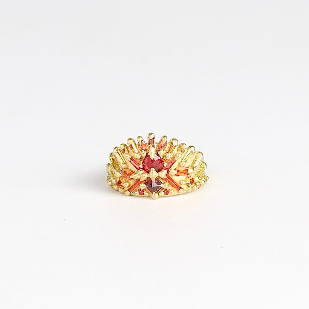 Neli Half Shield ring by Polly Wales is a Mixed cut orange to red sapphires (1.97tcw) in an OK exclusive one of a kind color way called "Carly-fornia Sunset" layered on 18k recycled yellow gold band. Cast not set. 