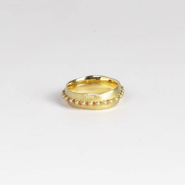 Nina ring in Rainbow by Polly Wales, showing pink, orange and yellow round sapphires.