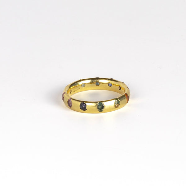 Celeste Ring in Blossom Crush by Polly Wales is a wide 18k recycled yellow gold band with sparkly rainbow sapphires in orange, yellow, green, pink, blue and purple peppered around the circumference. Recycled gold. Cast in Place. Cast not set. Handmade in Los Angeles.