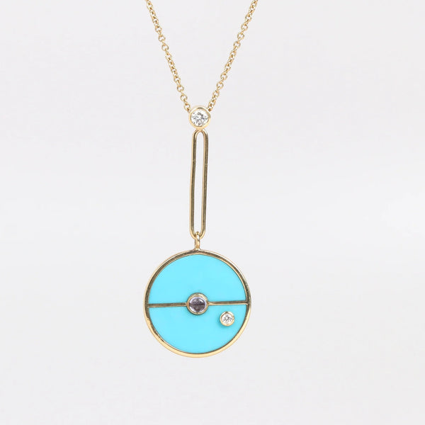 The signature Compass Pendant with Sleeping Beauty Turquoise and Tanzanite by Retrouvai is a pendant necklace with stone inlay that is accented with a center gem stone and a white diamond. The compass hangs from an elongated paperclip link accented with a second white diamond on 24" 14k yellow gold chain.