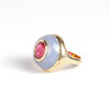Petite Lollipop Ring Rubellite Oval in Chalcedony by Retrouvai is a one of a kind ring featuring a chunky and rounded stone face with a translucent center stone set on a&nbsp;tiered edge and tapered band. This one features hand carved chalcedony with an oval cut rubellite in the center. Handcrafted in Los Angeles.