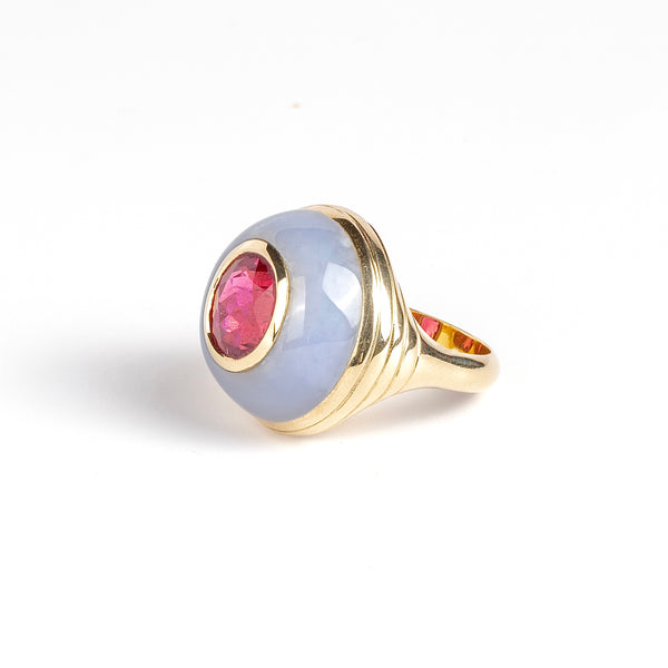 Petite Lollipop Ring Rubellite Oval in Chalcedony by Retrouvai is a one of a kind ring featuring a chunky and rounded stone face with a translucent center stone set on a&nbsp;tiered edge and tapered band. This one features hand carved chalcedony with an oval cut rubellite in the center. Handcrafted in Los Angeles.
