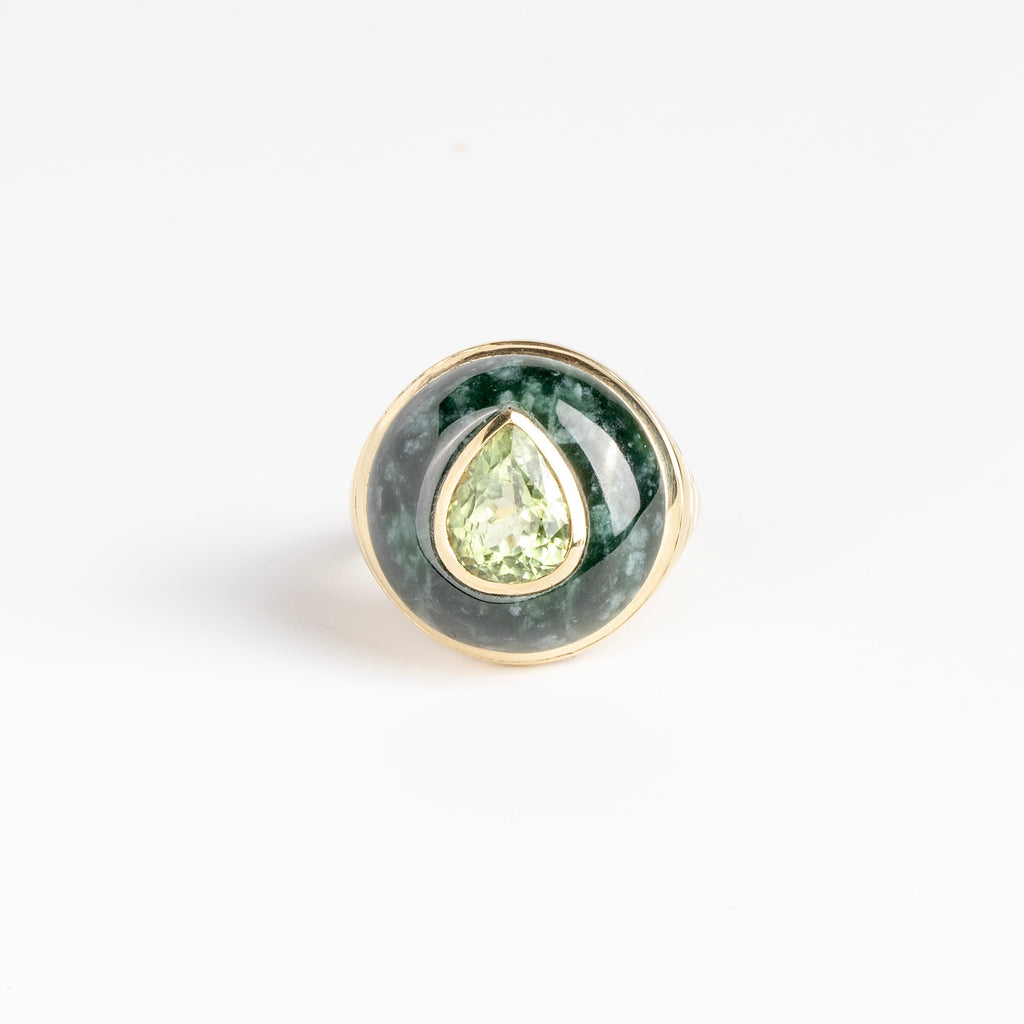 Petite Lollipop Ring in Tourmaline Pear and Green Jade by Retrouvai is a one of a kind ring featuring a chunky and rounded stone face with a translucent center stone set on atiered edge and tapered band. This one features hand carved jade with a pear cut mint green tourmaline in the center.