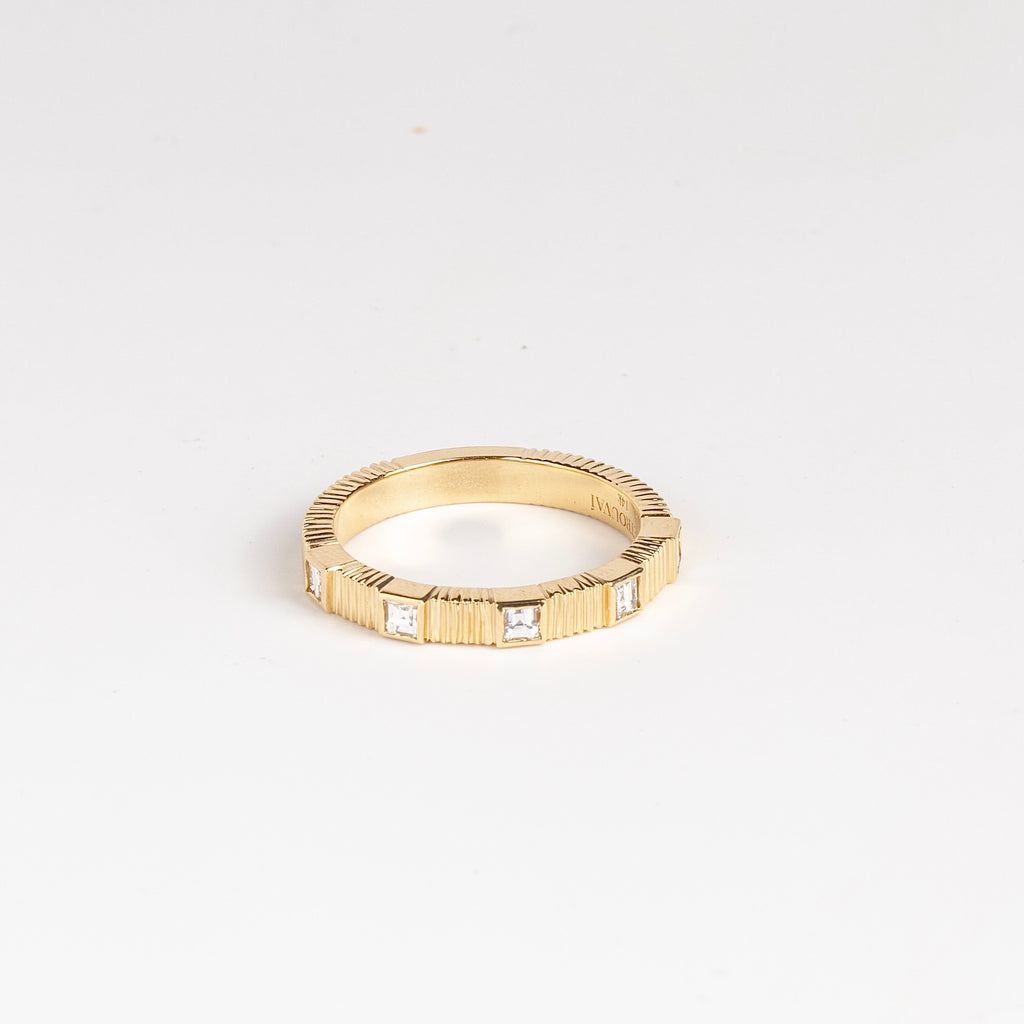 Pleated Five Stone Band Diamond Carre by Retrouvai is a wedding band ring made out of five carre cut diamonds in a pleated 14k yellow gold band. Size 6.5 in stock