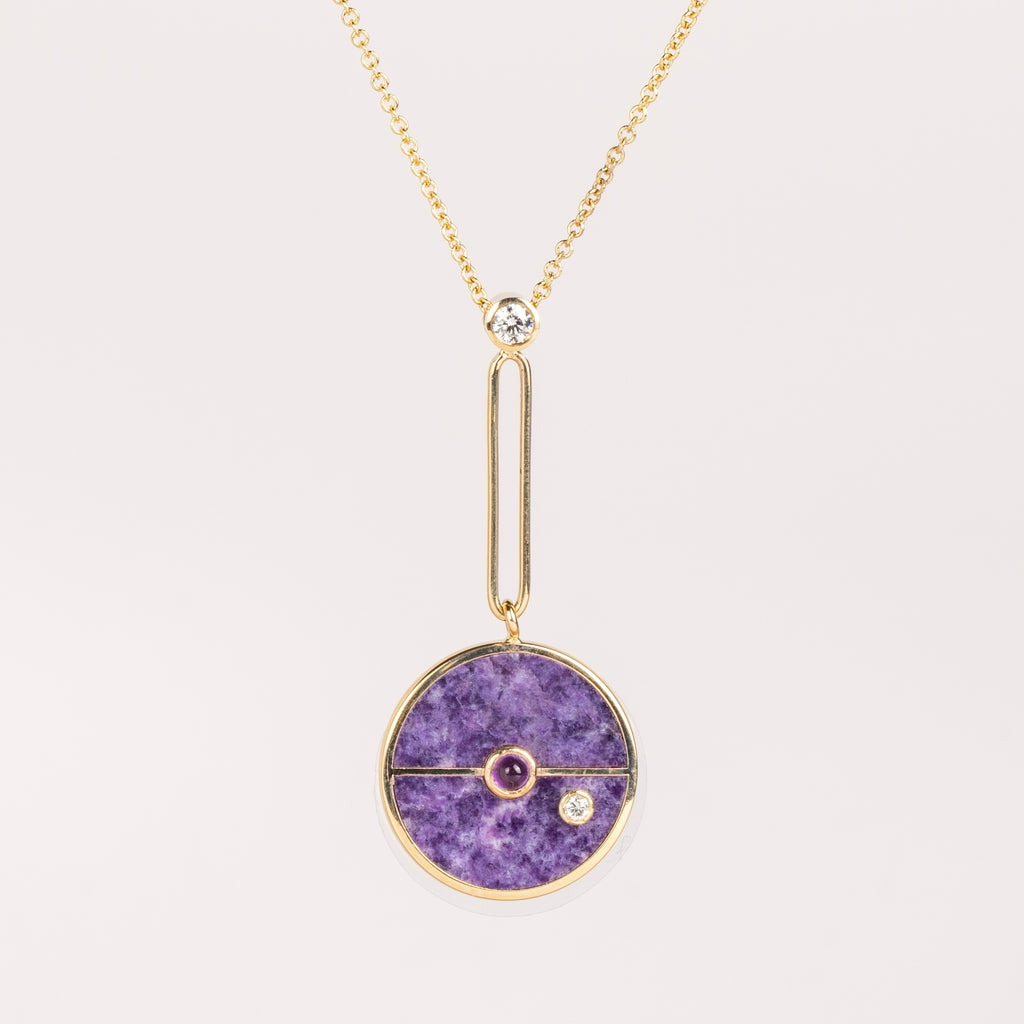 The Signature Compass Pendant in Lepidolite and Amethyst from Retrouvai is a unique modern take on an heirloom pendant. Stone inlay is accented with a center gem stone and white diamond. The compass hangs from an elongated paperclip link accented with a second white diamond. Handcrafted in Los Angeles.