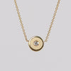 Retrouvai Mini compass pendant in brushed gold.