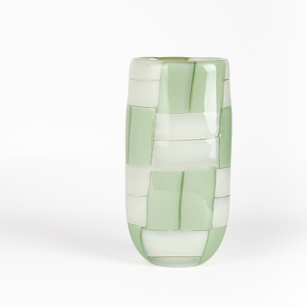An  oval cylinder basketweave vase in green and white by Robin Mix whose sensibilities come from his training in Scandinavia, but is produced using the most sophisticated and iconic of traditional modernist Italian techniques. Vase is signed. 