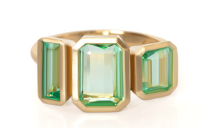 Studio shot of Emerald trio ring.