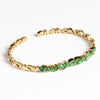 18k Zig Zag Firework Bangle in Emerald by Suzanne Kalan on white background.