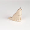 A howling wolf toy or figurine from T-lab, handmade in Bali from albizia wood, a lightweight fast-growing wood from the South Pacific. 