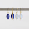 Large Moon Earrings by Tej Kothari one white background. 