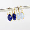 Large Moon Earrings by Tej Kothari one white background. These are cabachon stones set in 18k gold on earwire. Lapis and Chalcedony. 