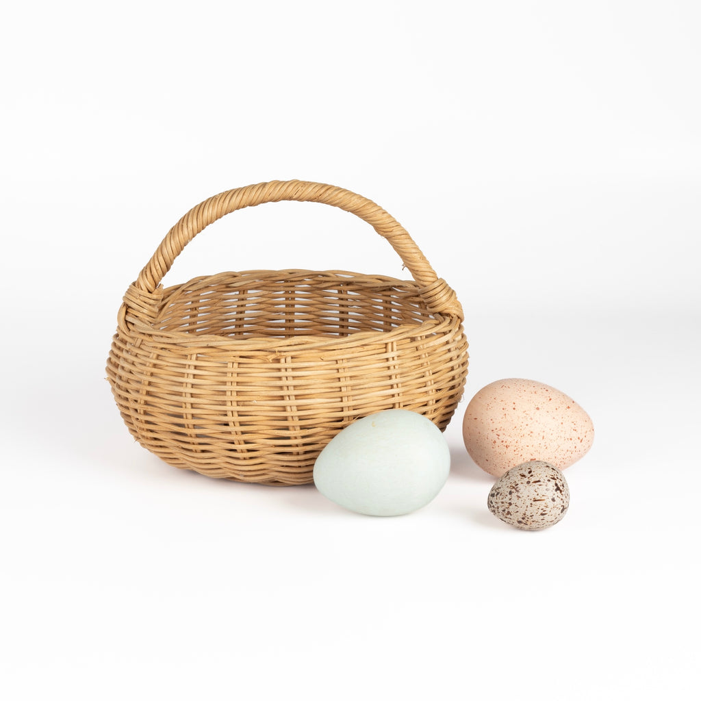Birds eggs in a basket toy is a great carry along toy made out of a rattan basket and 12 eggs, mimicking bird eggs in a farm, painted in beautiful muted colors with speckled details.