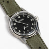 Weiss Watch 38mm Automatic Field Watch with Black Dial and date, shown with  olive rubber strap and white background.