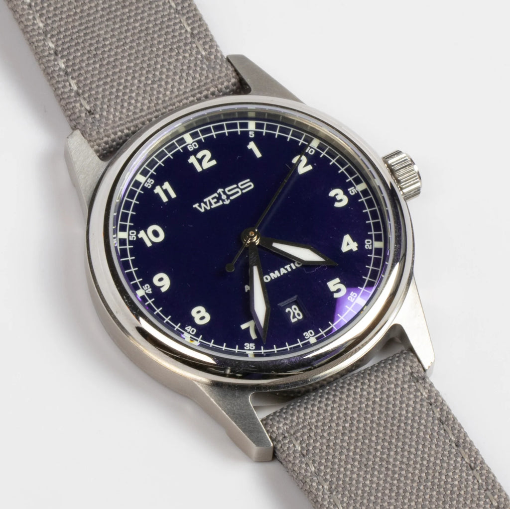 38mm Automatic Issue Field Watch with Blue Dial and Date and Gray Canvas band on white background.