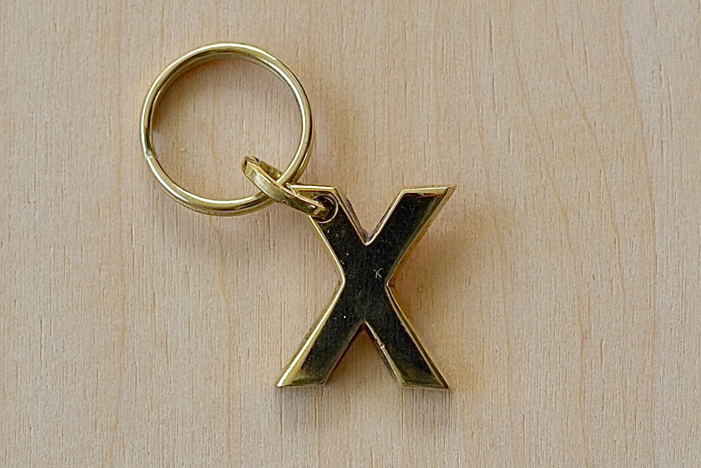 'X' Letter keyring, key chain, key ring in brass made by Carl Aubock. 