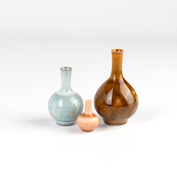 Miniature Hand Thrown Ceramic trio of vases by Yuta Segawa. One cloud blue with perferations, one brown and one peach with perforations.