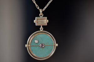 
            
                Load image into Gallery viewer, Back of  Grandfather Compass Pendant in Green Turquoise and Tanzanite by Retrouvai is a pendant necklace with stone inlay that is accented with a center gem stone in the front and back, and nine (9) round white diamonds.
            
        