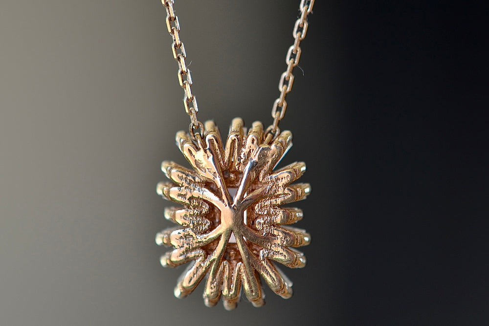 Back of Suzanne Kalan Pink Sapphire Necklace with Diamond Baguette Halo on firework setting.