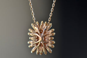 Back of Suzanne Kalan Pink Sapphire Necklace with Diamond Baguette Halo on firework setting.