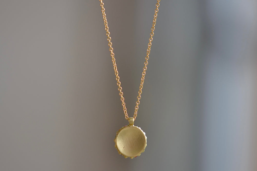 Back of Pastel Blossom River Domed Necklace designed by Polly Wales. Recycled gold.