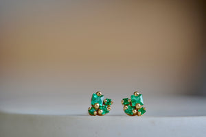 Close up of 18k Princess Emerald Studs earrings with post closure by Suzanne Kalan.